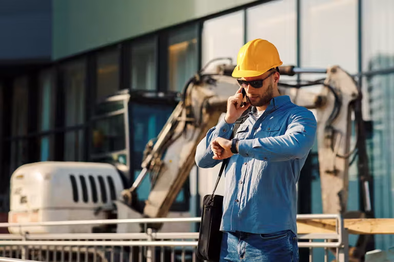 Contractor on a Huntington WV jobsite checking his phone between leads and closed jobs